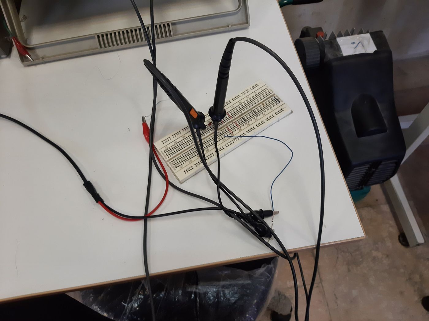 A breadboard circuit with two oscilloscope probes attached
